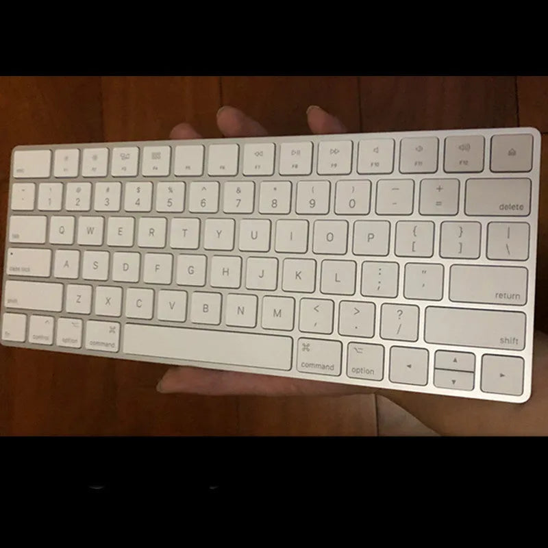 White Apple ultra-thin metal Bluetooth G6 wireless keyboard on a desk.