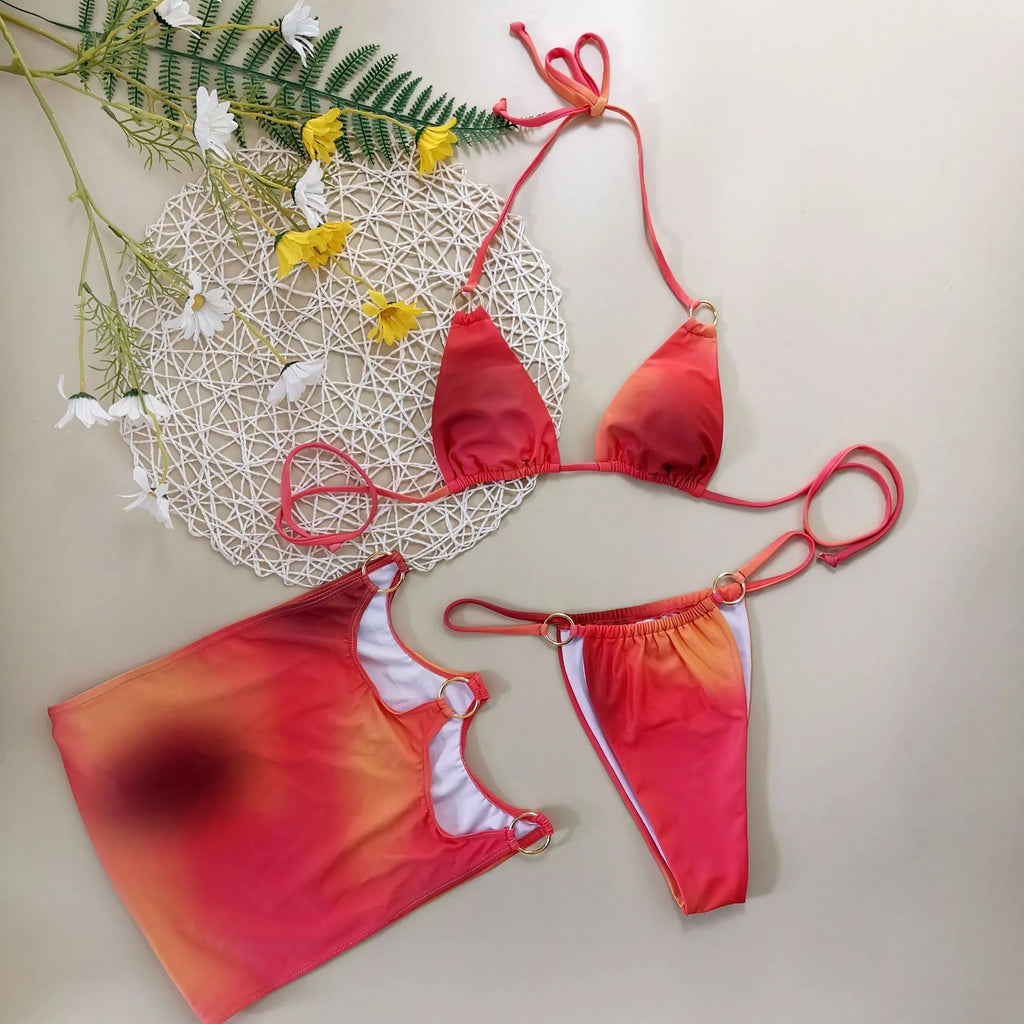 Women's tie-dye gradient three-piece bikini set with halter neck top and matching skirt.
