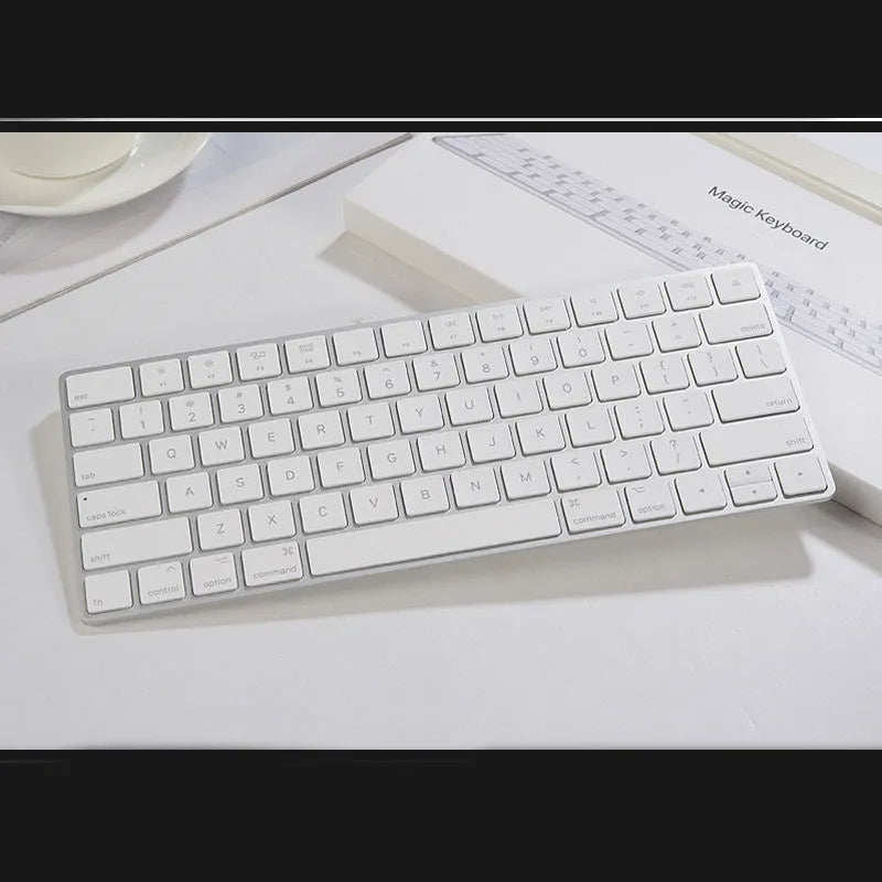 White Apple ultra-thin metal Bluetooth G6 wireless keyboard on a desk.