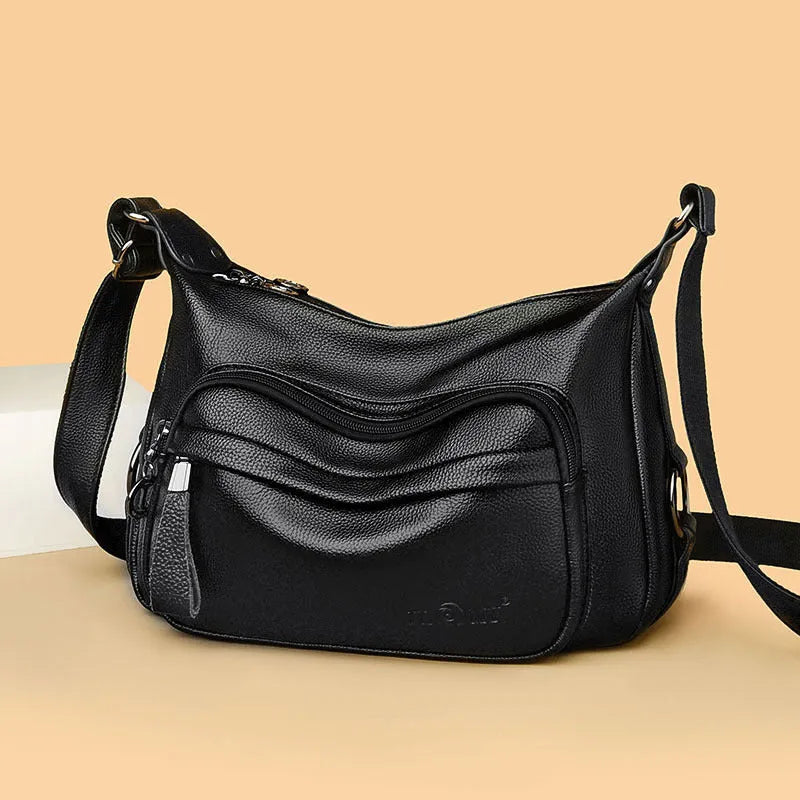 Blue horizontal square women's shoulder bag with soft PU construction and visible sewing thread detailing