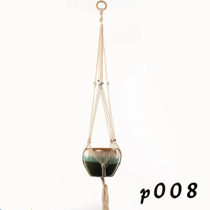 Woven cotton rope plant holder in a desktop style with greenery inside.