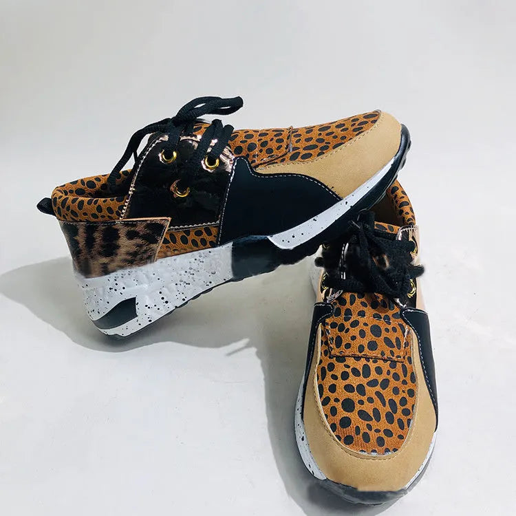 Women's casual suede sneakers with a wedge heel in various colours including black, pink, and leopard print.