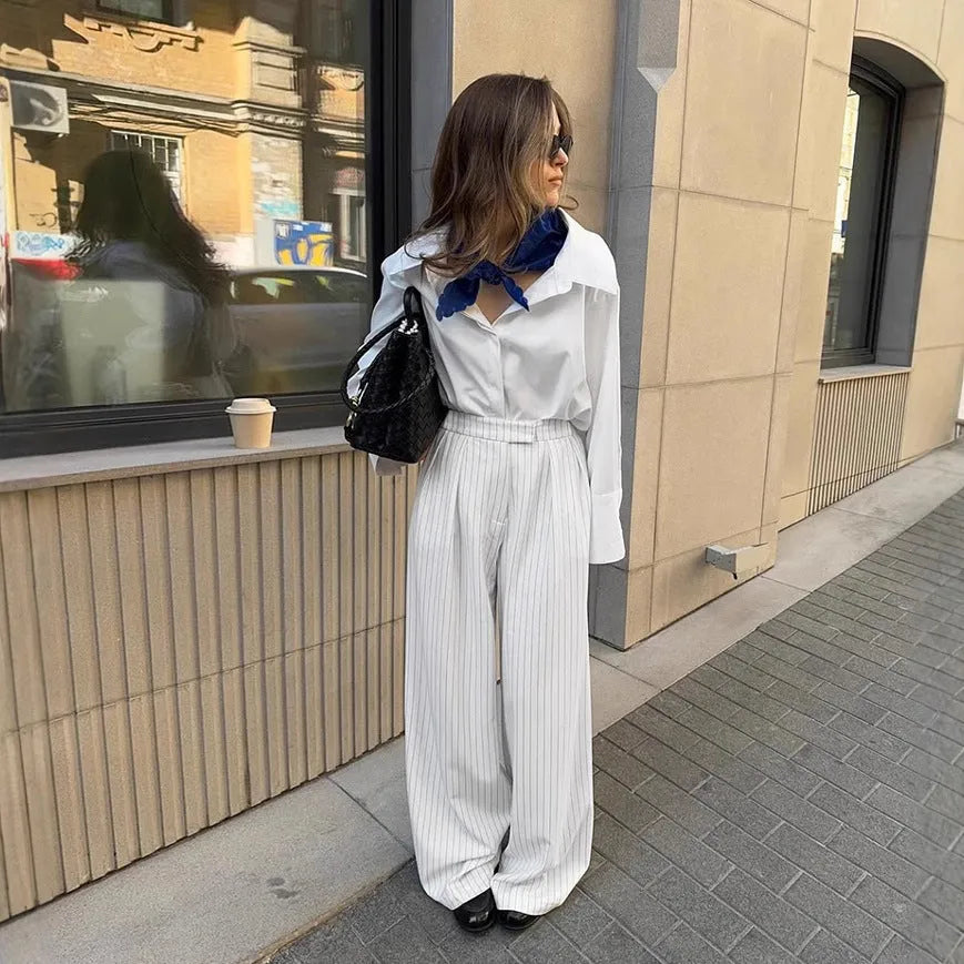 White wide-leg trousers with vertical stripes, loose casual fit, zipper detail, suitable for commuting and office wear
