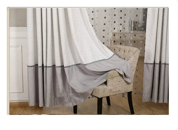Simple blackout curtain panel hanging, showing light-blocking fabric and hook heading style.