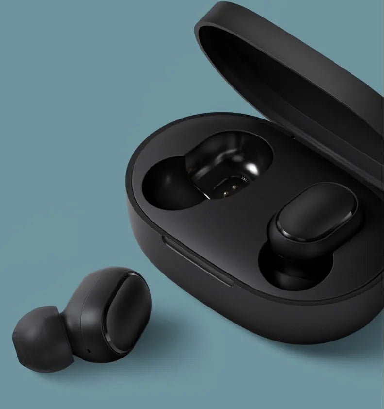 Redmi AirDots Black true wireless earbuds and their white charging case on a table