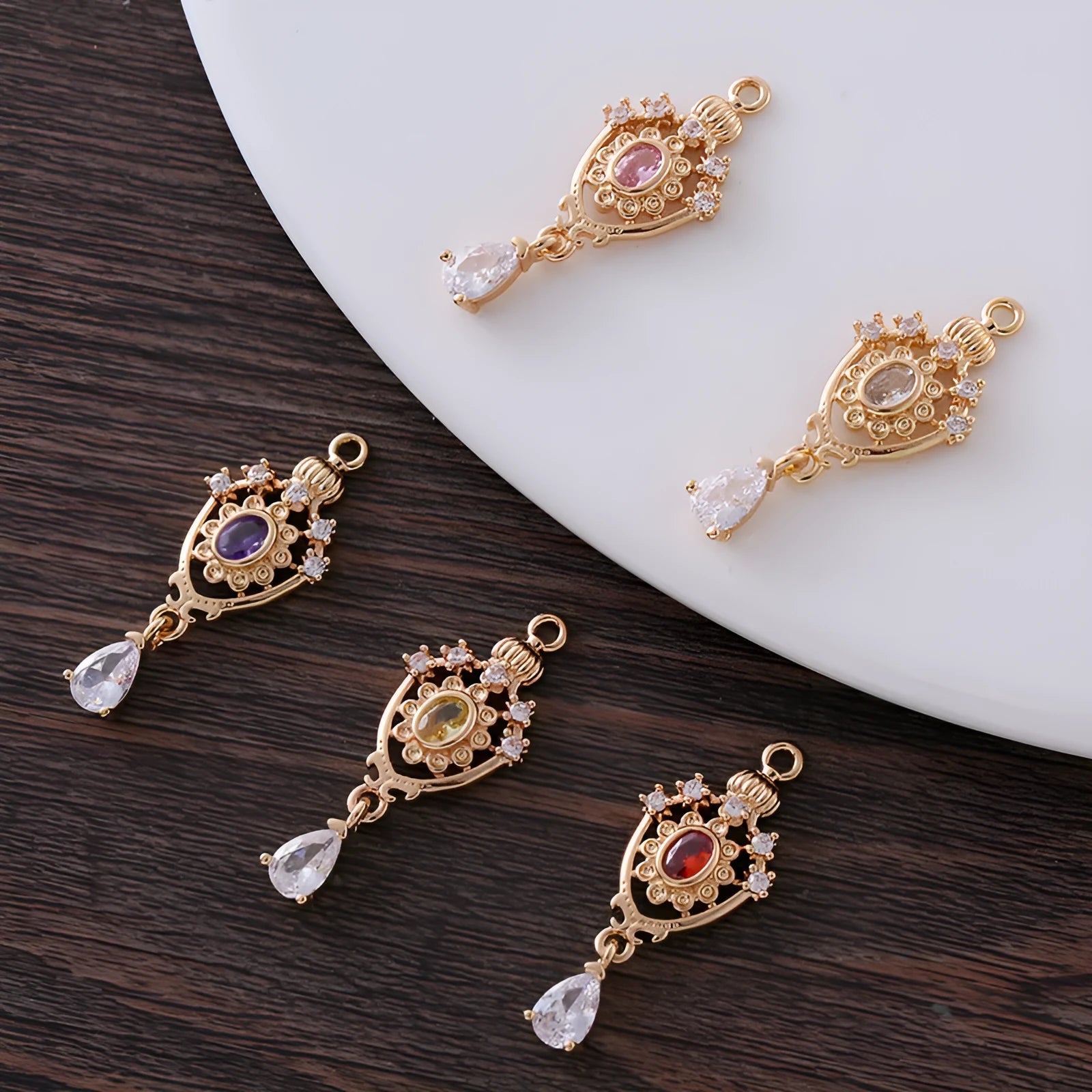 Small copper water-drop pendant with crown design in assorted colours.
