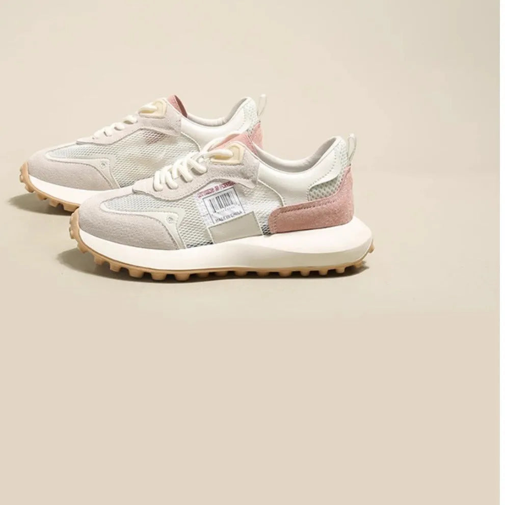 Women's grey retro sneaker with round toe and rubber sole showing mesh lining interior