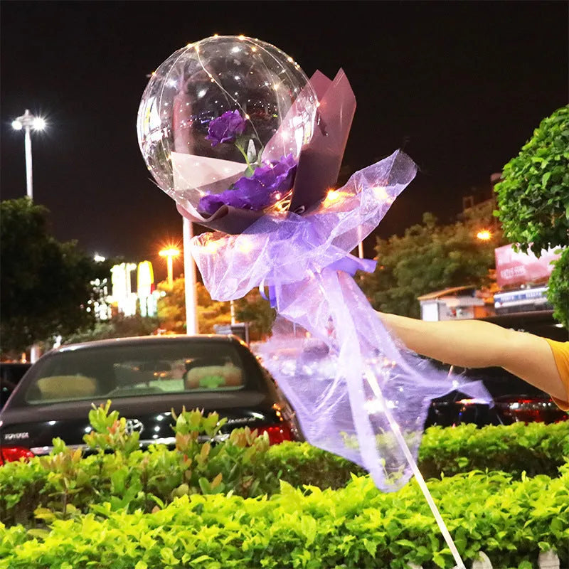 Transparent LED luminous balloon bouquet with artificial rose and glowing light inside, displayed as a DIY kit.