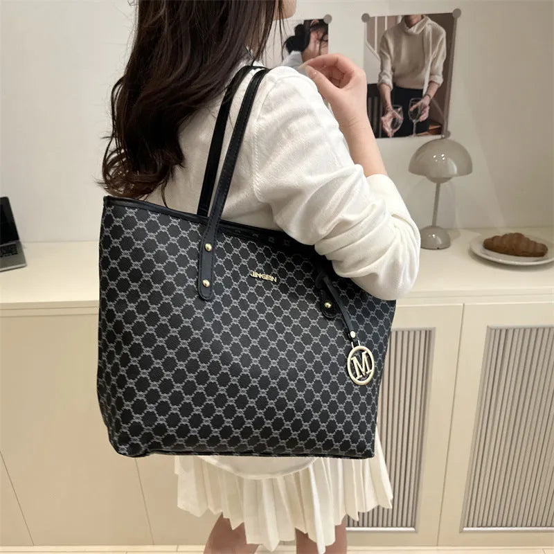 Structured black PU shoulder bag with sewing thread detail and a polyester lining.
