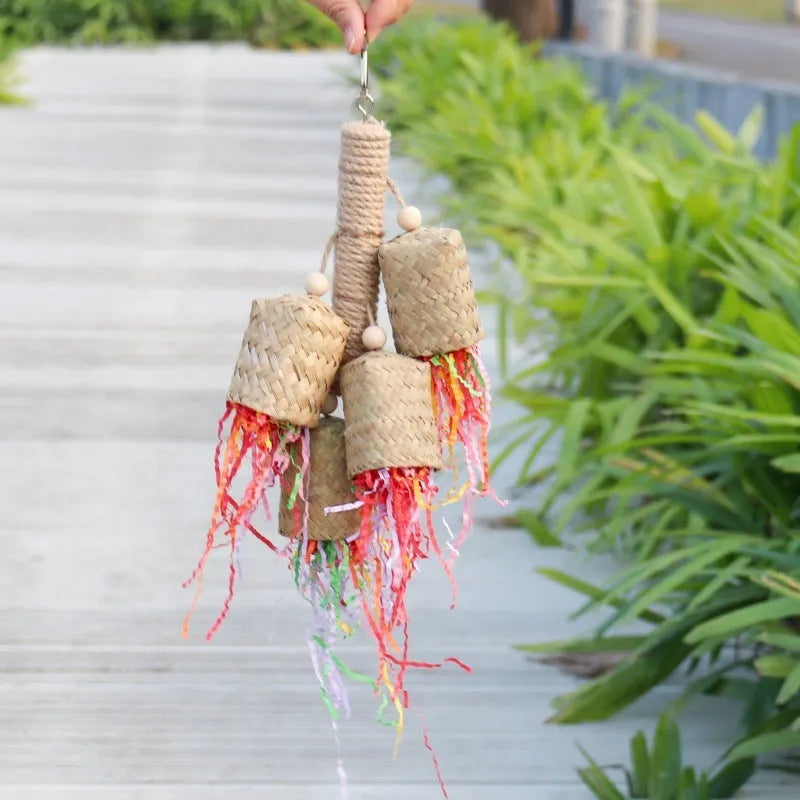 Colourful shredded paper parrot toy made of wood and sisal rope, measuring 35cm long.