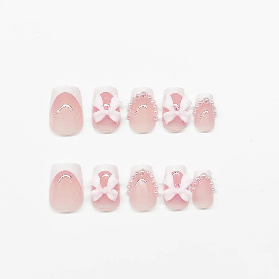 Short white French fake nails with cute bow and tulip patterns for ladies manicure