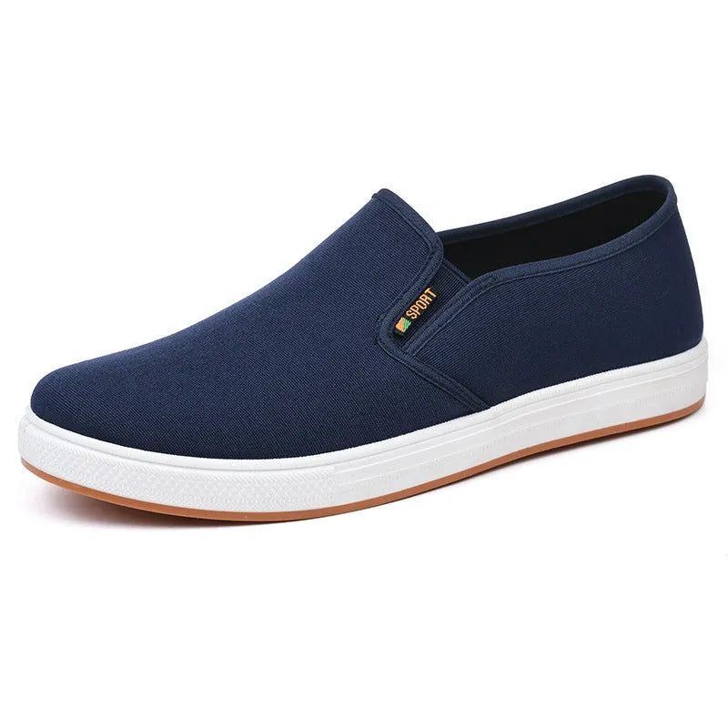 Men's black low-top slip-on canvas shoes with a round toe and composite sole on a white background.