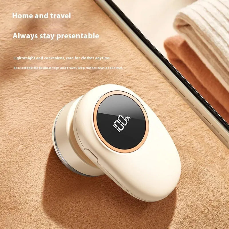 Beige and purple electric fur ball trimmer lint rollers with digital display and rotating cutter heads on a fabric surface.