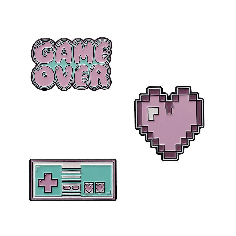 Stereo game console metal badge in protective OPP packaging, shown in one of three colour variants.