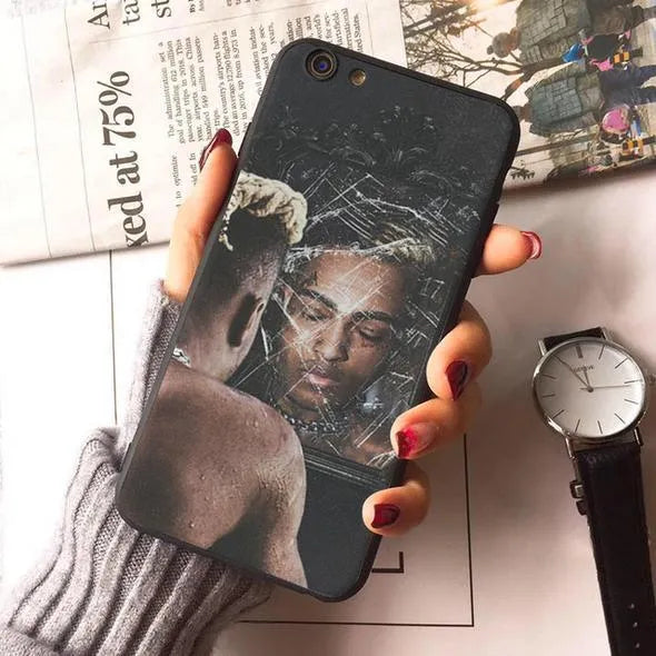 Half-wrapped transparent iPhone case with XXTentacion artwork design showing matte finish texture