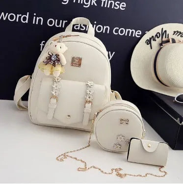 Three-piece women's bag set showing backpack, shoulder bag, and card wallet in matching colour
