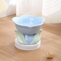 Blue ceramic elevated pet bowl with floral pattern for cats and small dogs on a non-slip base.