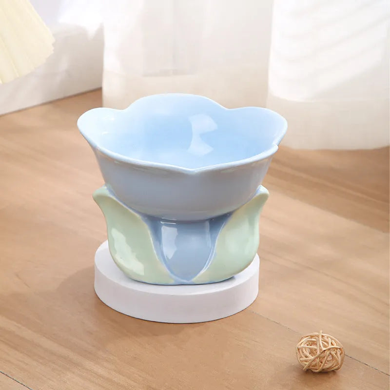 Blue ceramic elevated pet bowl with floral pattern for cats and small dogs on a non-slip base.