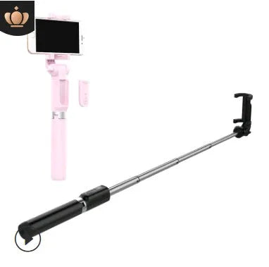 Black Bluetooth selfie stick tripod with remote control extended next to mobile phone