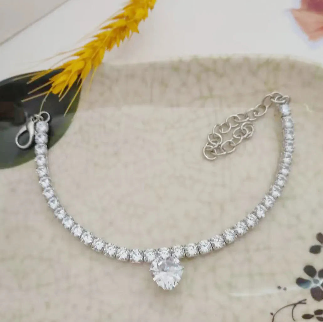 Gold rhinestone heart-shaped collar for dogs and cats with shiny stones and metal extension chain.