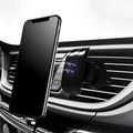 Black universal car phone holder attached to a car air vent.