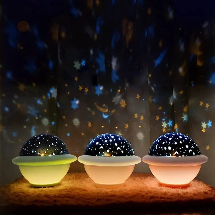 Green UFO-shaped starry sky projection night light on a table, showing rotating planet display on wall.