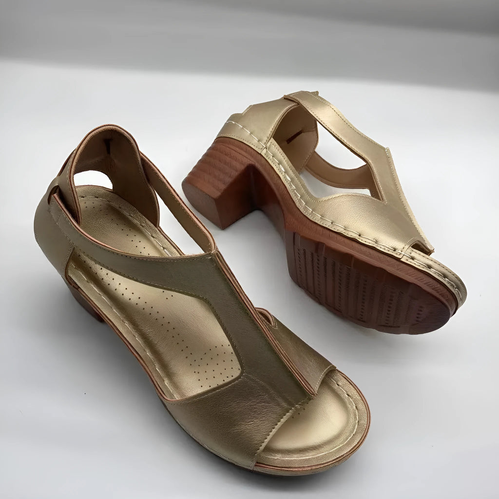 Plus size women's beige open toe wedge sandals with a buckle strap and low heel on a white background.