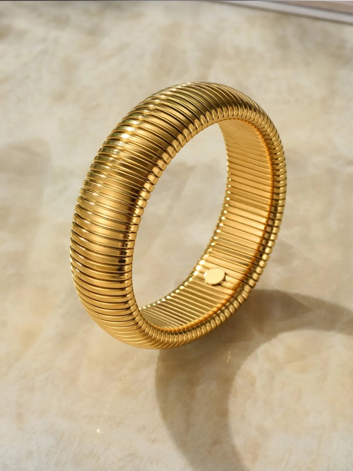 Women's elastic titanium steel bracelet with vertical stripe ring pattern in gold electroplated finish
