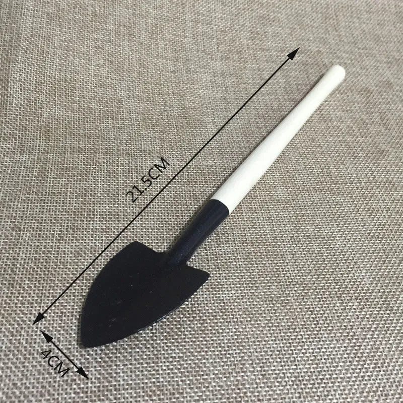 14-piece plastic succulent gardening tool set showing drip kettle, mini shovels, tweezers, and brush on a table.