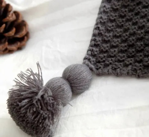 Nordic fringed knit ball acrylic blanket in beige colour, laid flat showing 130x170cm size and fringe detail