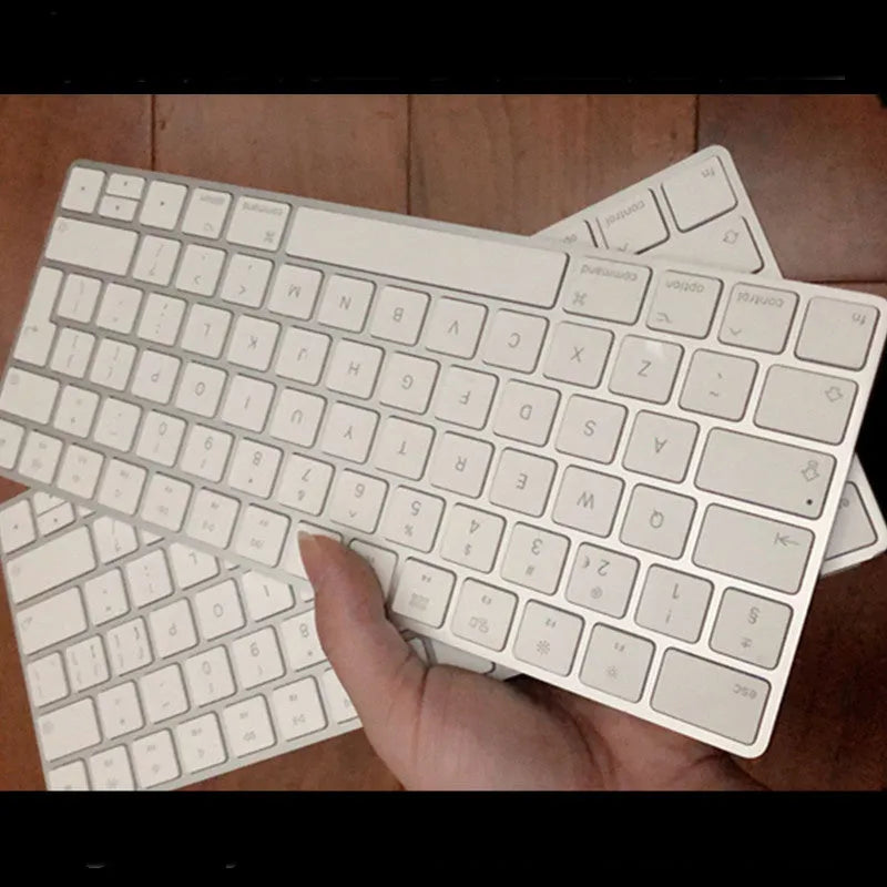 White Apple ultra-thin metal Bluetooth G6 wireless keyboard on a desk.