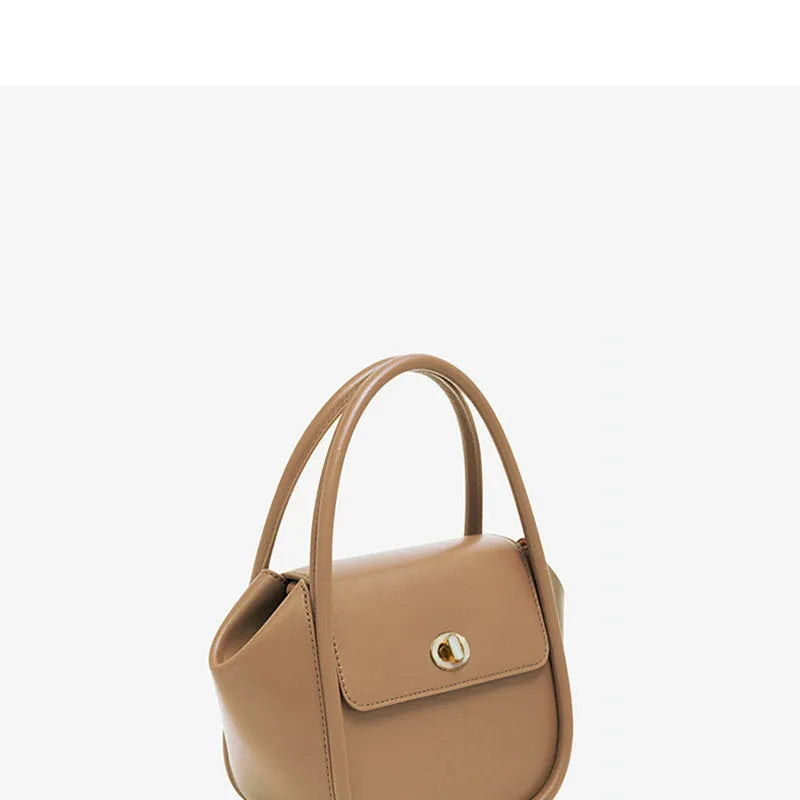 A soft cow leather wing-shaped tote handbag with a buckle and shoulder strap in black.