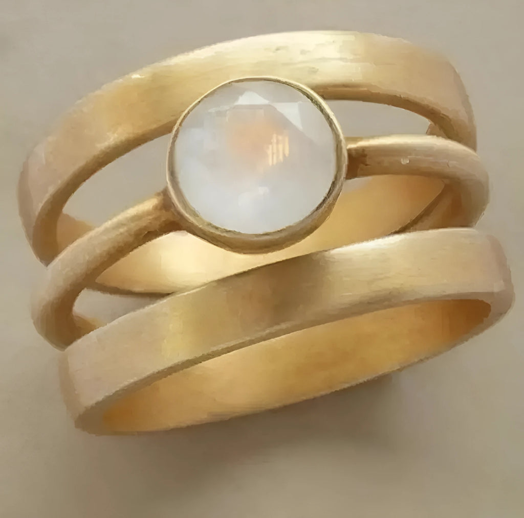 Geometric gold-plated titanium steel ring with hollow framework and micro-inlaid white chalcedony stone
