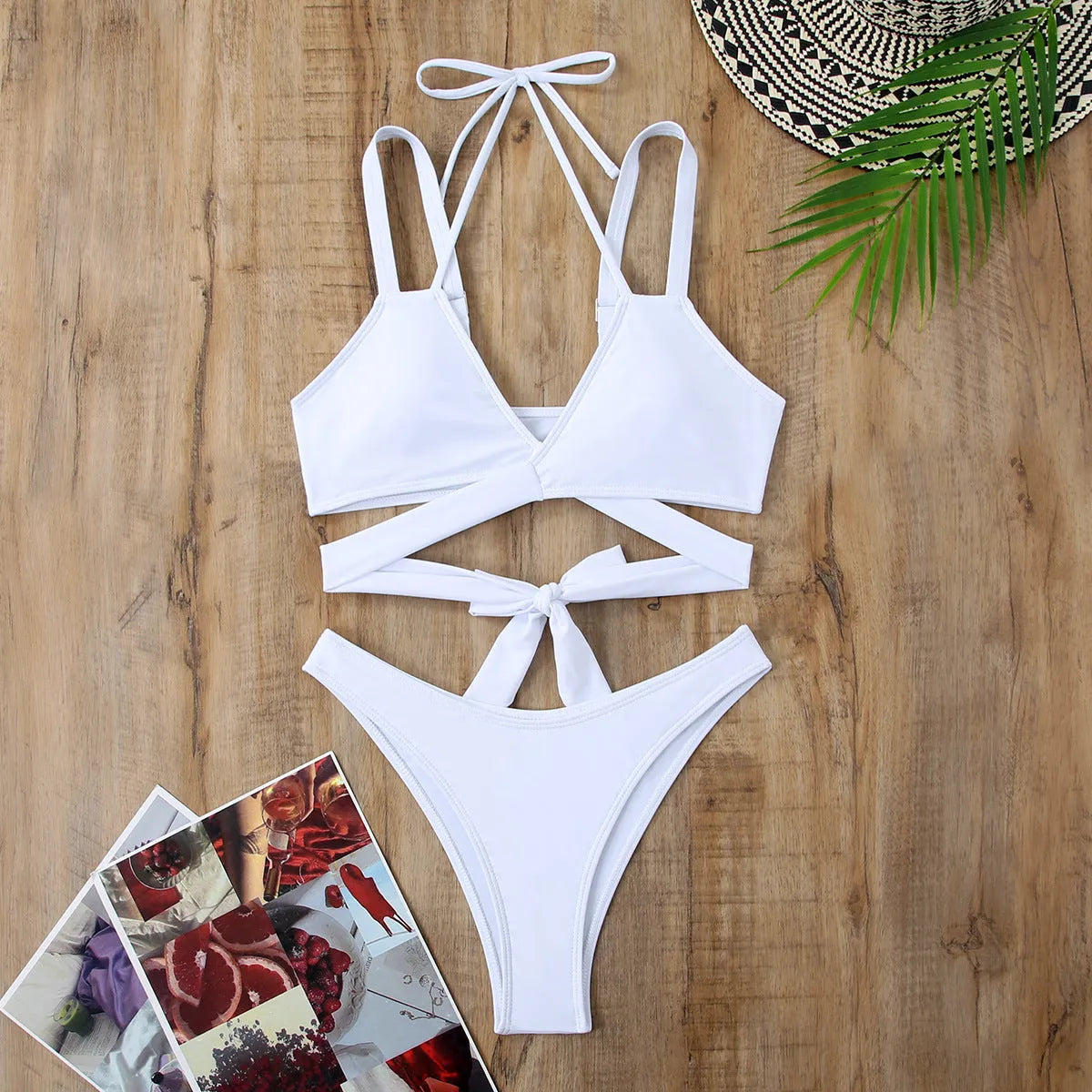 Women's solid colour strap bikini swimsuit in a brief style on a white background.