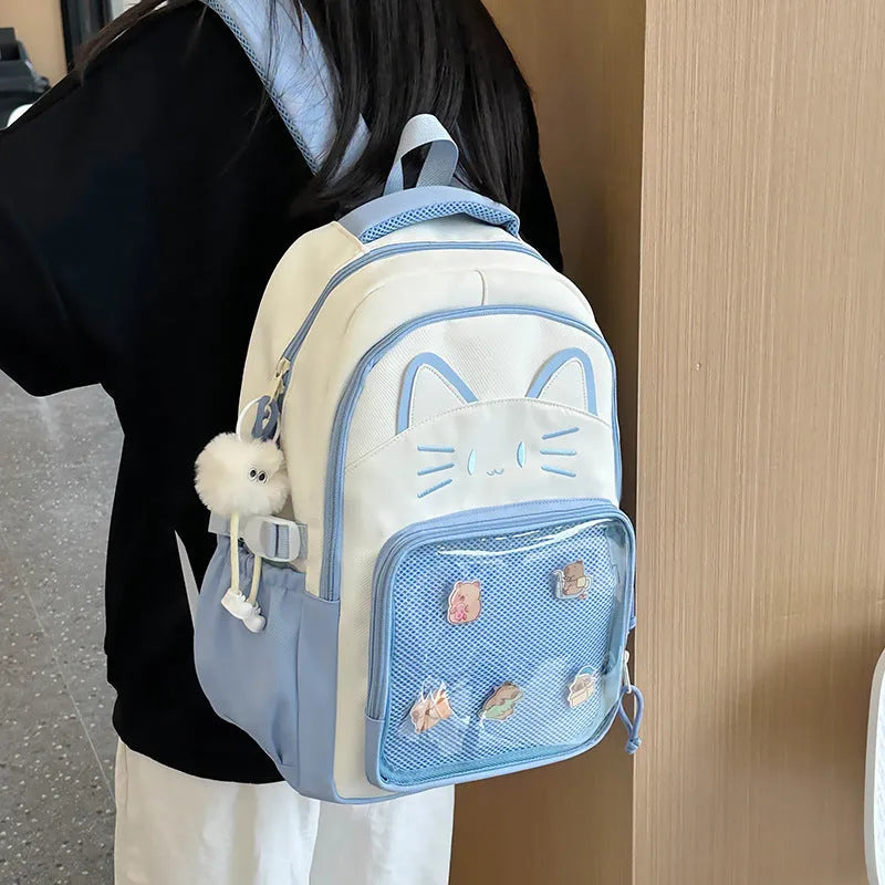 Korean cartoon large capacity nylon backpack in pink colour with badge pendant.