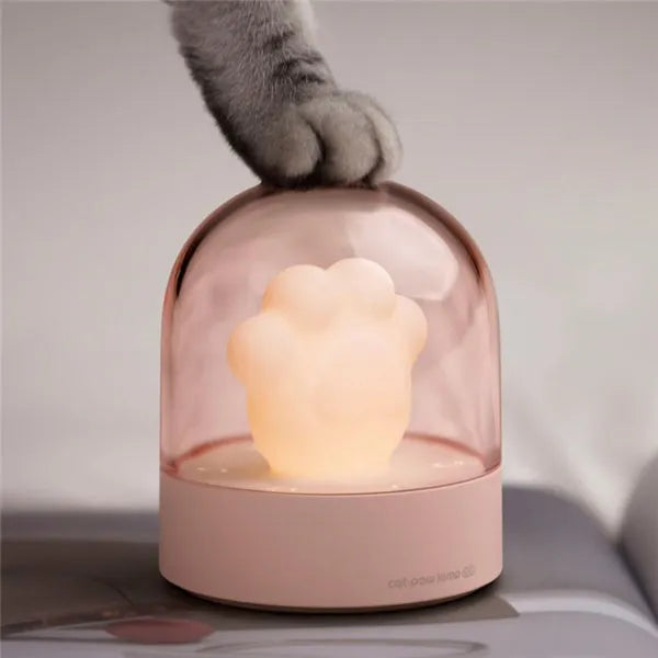 Grey and pink cat paw shaped USB rechargeable night light with adjustable brightness and musical rotation features