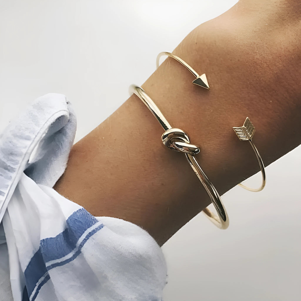 Gold-toned vintage women's cuff bracelet with an intricate arrow knot design.