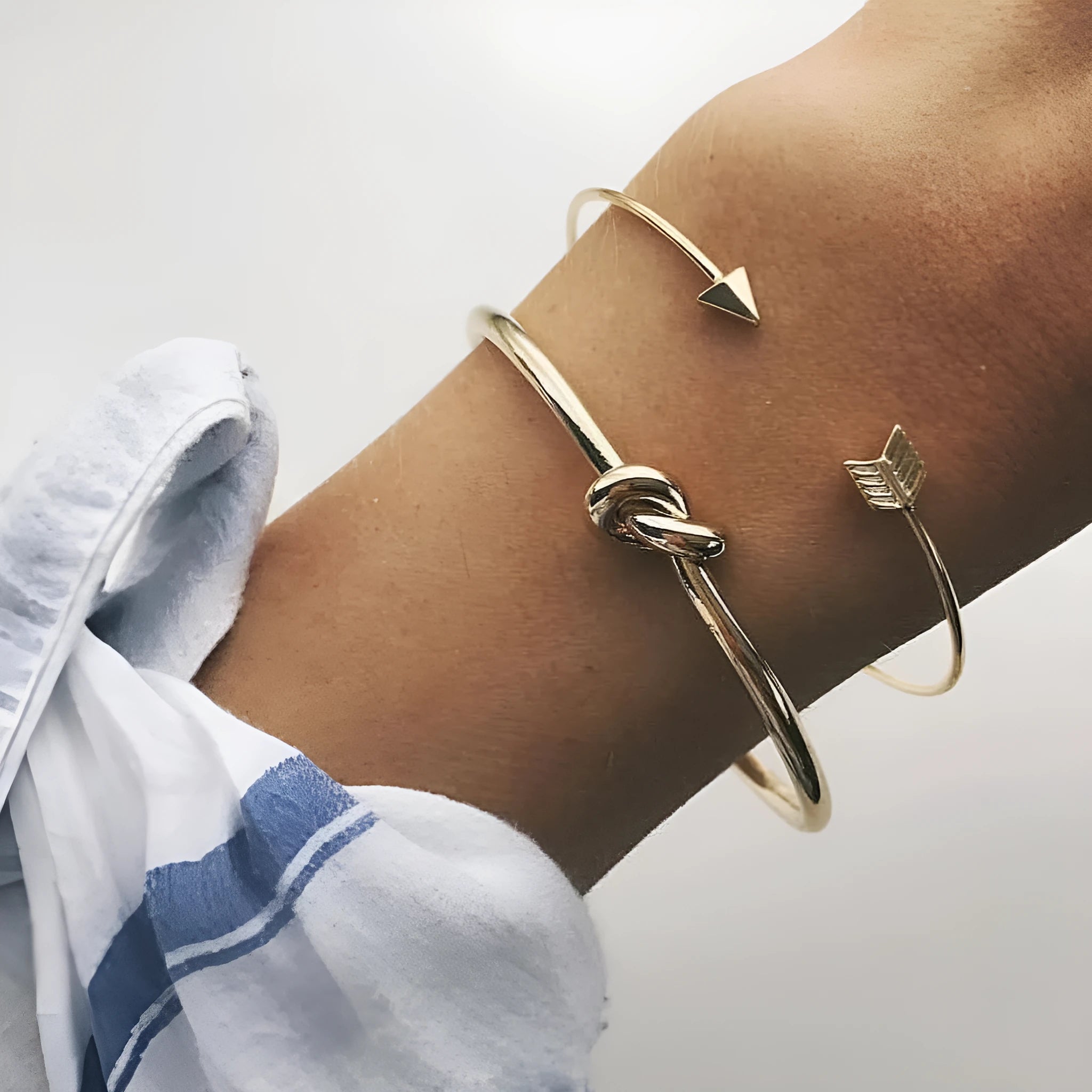 Gold-toned vintage women's cuff bracelet with an intricate arrow knot design.