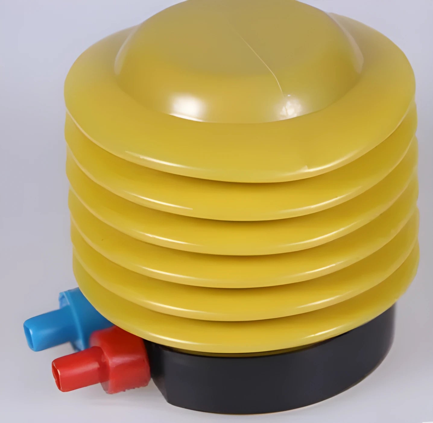 Blue and red plastic manual pedal pump for inflating swim rings, shown with two valve adapters.