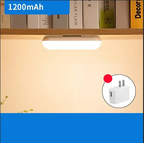 Compact white magnetic table lamp with a large luminous surface and USB charging port.
