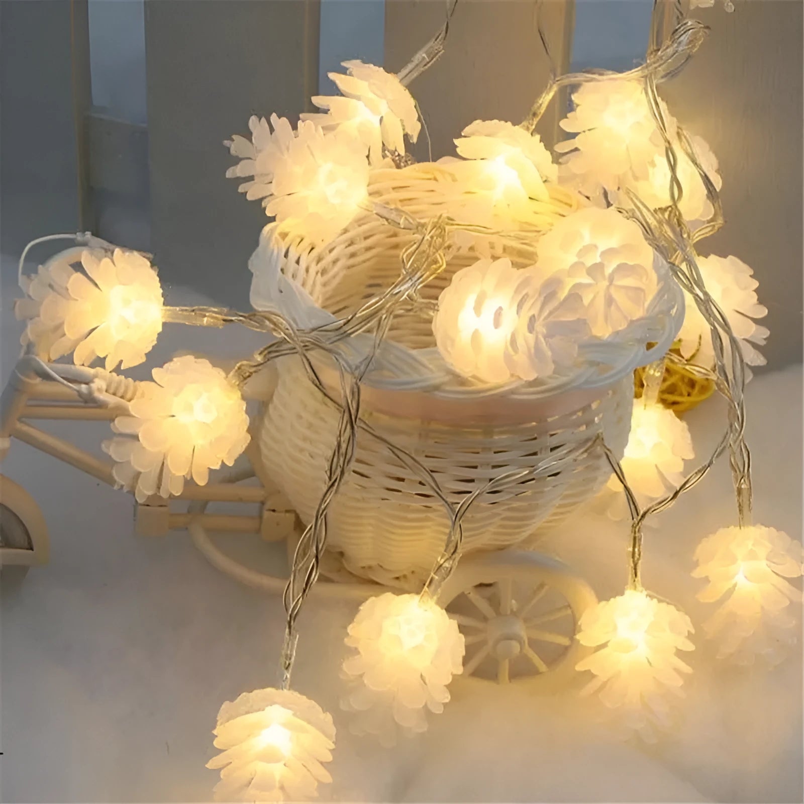 Warm white LED pine cone fairy lights on a string, powered by batteries for cord-free decoration.