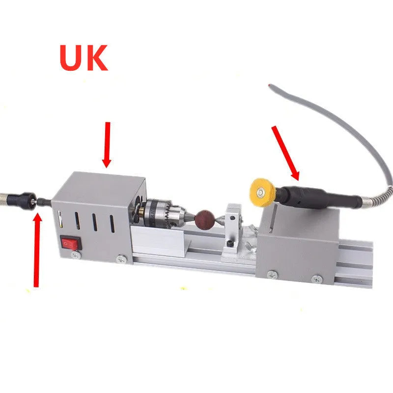 Silver metal mini woodworking lathe with carving knives on a workbench
