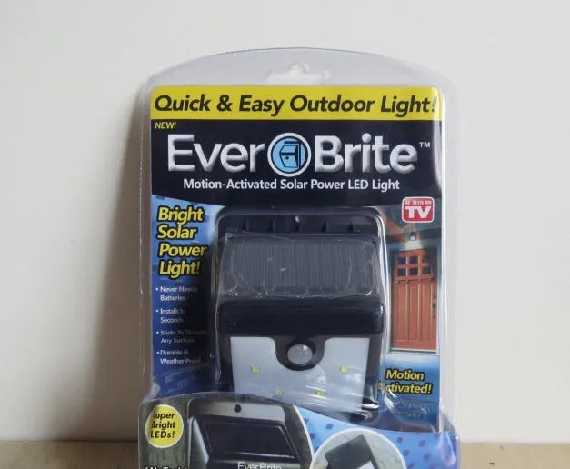 Solar-powered outdoor LED sensor light with four adjustable light heads for garden security