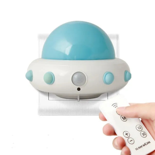 Remote control UFO shaped bedside night light in blue, pink, or white colour.