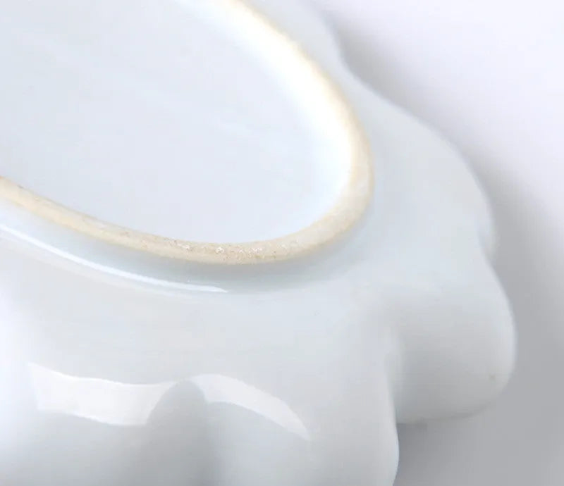 White ceramic plum blossom shaped artist's palette for paint mixing