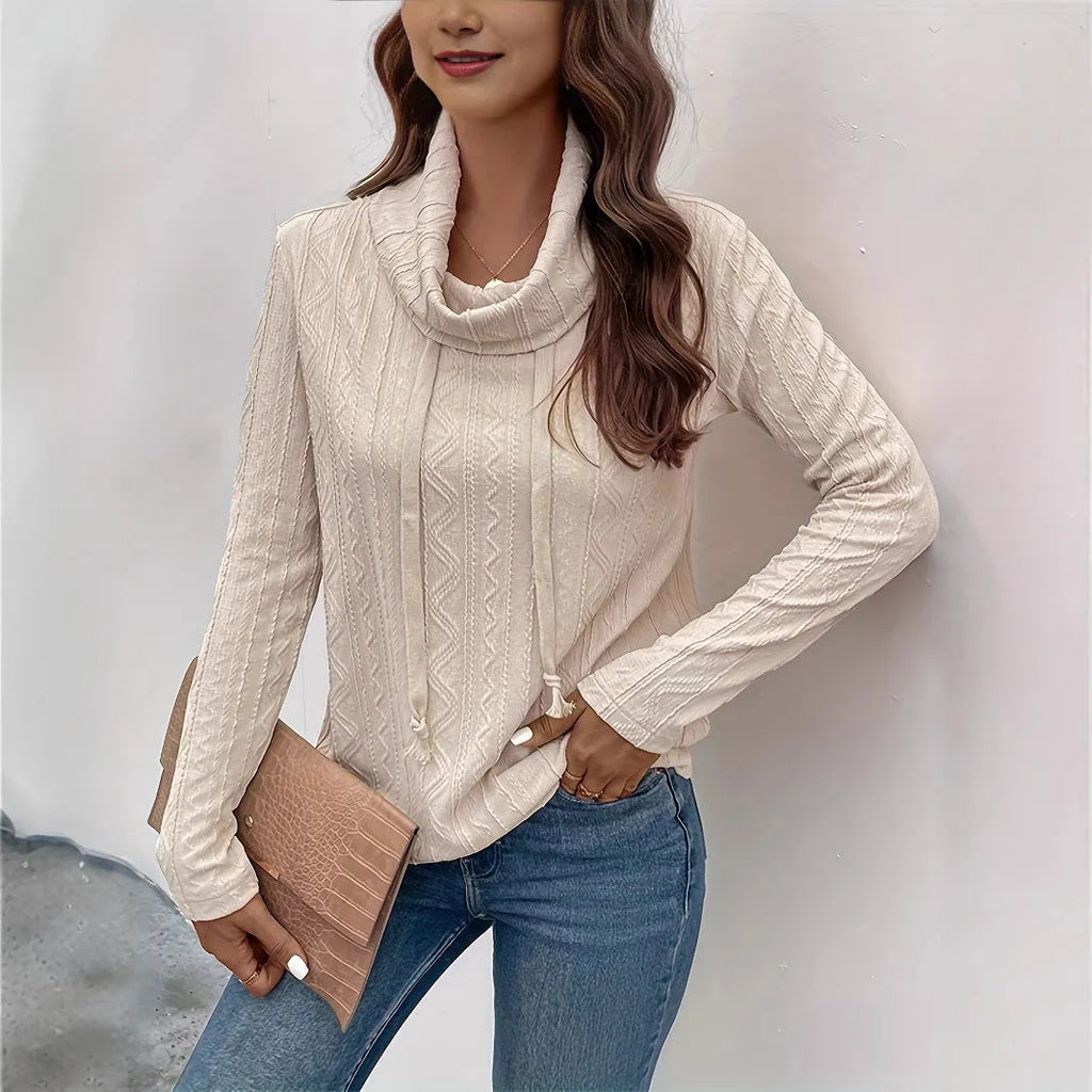 Apricot coloured long sleeve hooded pullover sweater with a drawstring, shown on a hanger.