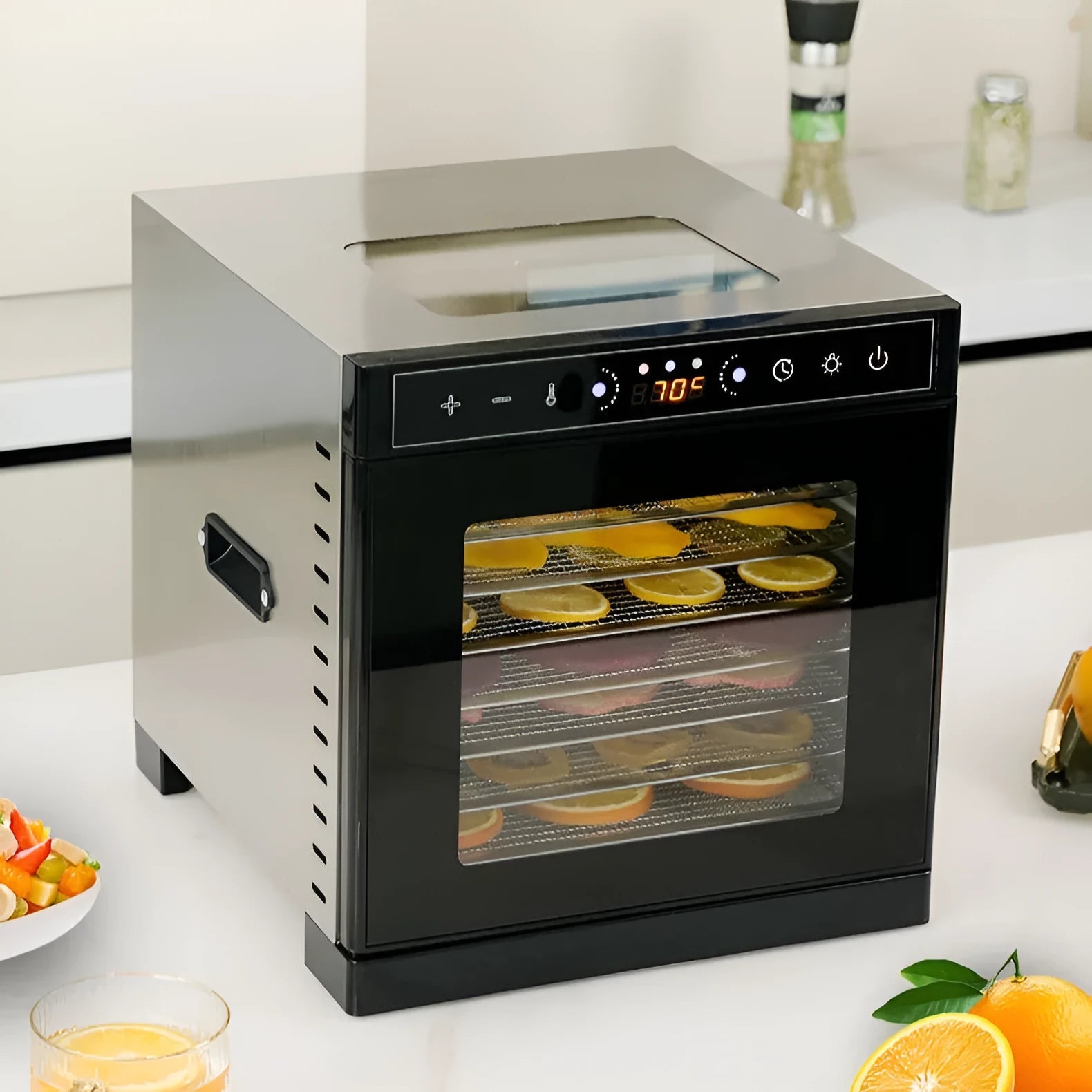 Stainless steel fruit dehydrator with LED control panel showing temperature settings and multiple drying trays