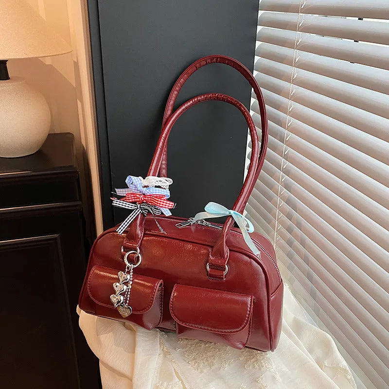 Retro brown PU leather women's shoulder bag with pillow-shaped design and double strap.