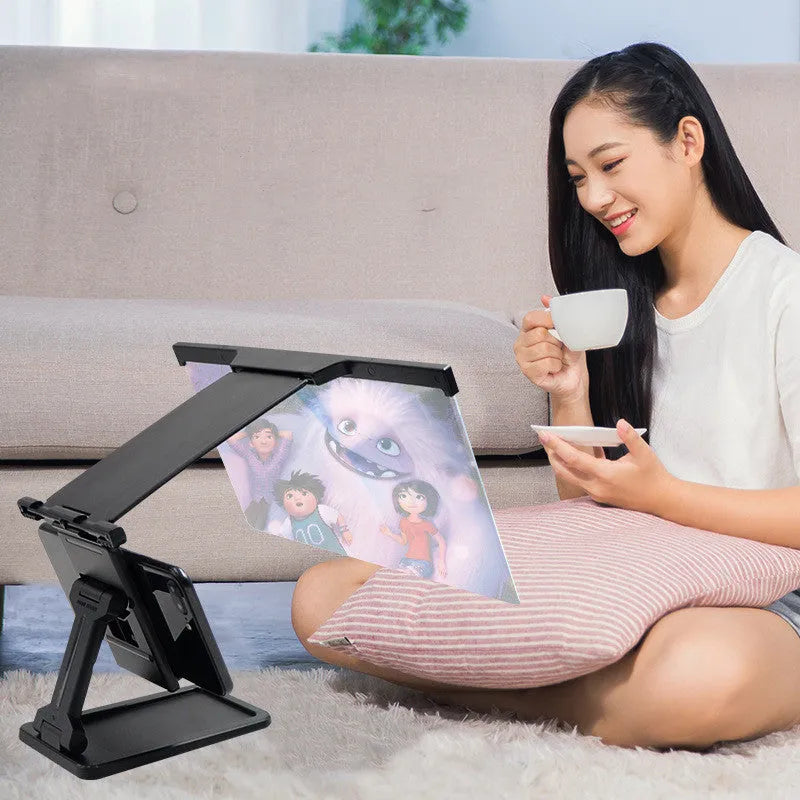 Black L20 split mobile phone screen magnifier with acrylic lens and separate support bracket on a table.