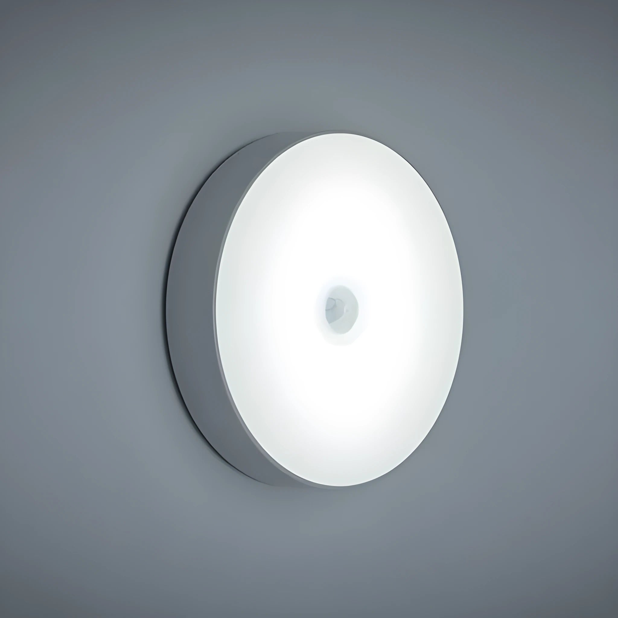 White USB rechargeable LED body induction night light with adhesive backing showing 86mm diameter